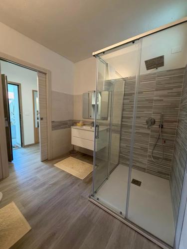a glass shower in a bathroom with a sink at Domos de Budroni B&B in Bono
