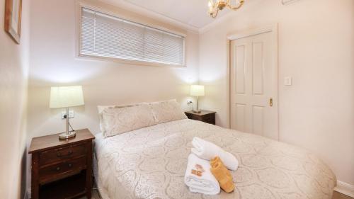 a bedroom with a bed with two towels on it at Chalets Lumineux in Bright