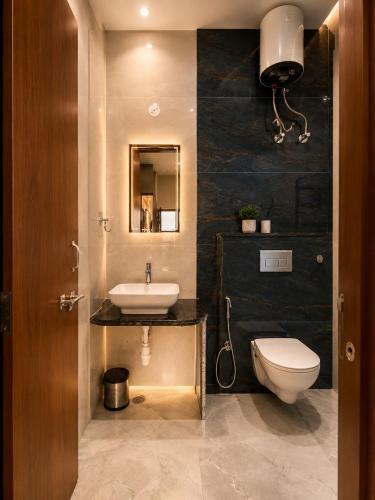 a bathroom with a white toilet and a sink at Vianara's Eco Feel Resort in Jaipur