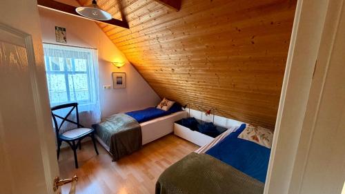 a room with two beds and a couch in it at Nýlenda - Charming Two Bedroom Seaside Property, Mountain and Town Views in Seyðisfjörður