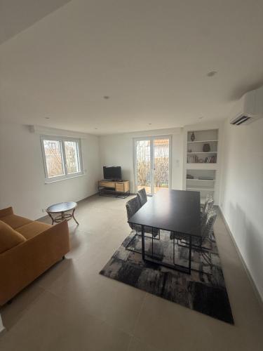a living room with a table and a couch at Cozy apartment in Vendenheim in Vendenheim