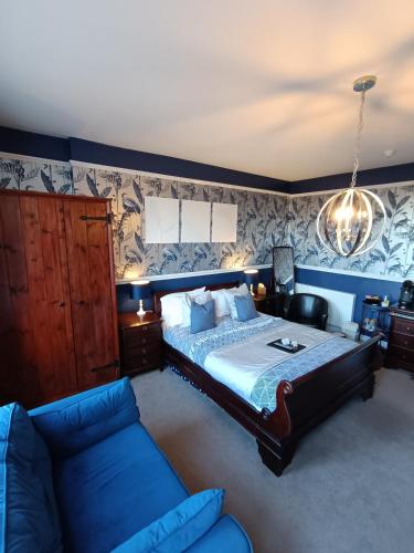 a bedroom with a large bed and a couch at Earlston House in Paignton