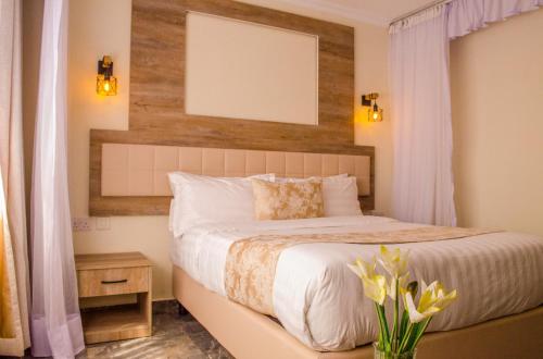 a bedroom with a bed with a white bedspread at ACK St.Julians Centre in Limuru