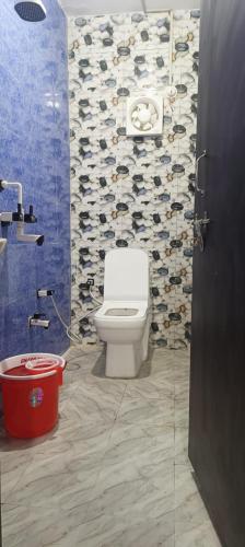 a bathroom with a toilet and a wall of shoes at kanakdhara aashraya in Vrindāvan