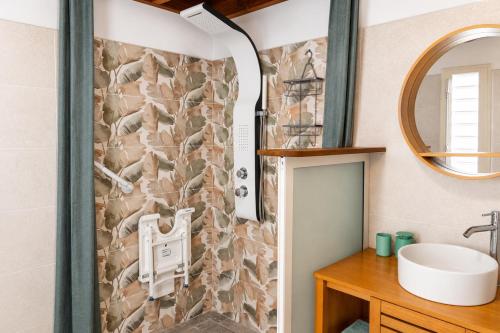 a bathroom with a sink and a shower at Le Cocon d'Ava - Bungalows & Spa in Saint-Paul