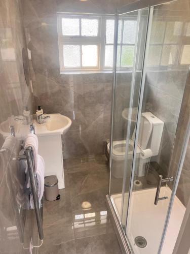 a bathroom with a shower and a sink at The Rivenhall Hotel in Rivenhall