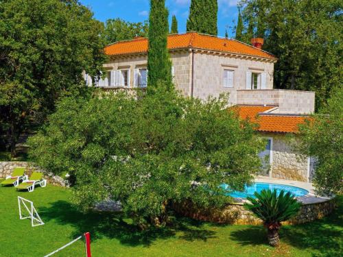 a large house with a swimming pool in a yard at Exclusive Villa with private pool huge fenced property near Dubrovnik in Čilipi