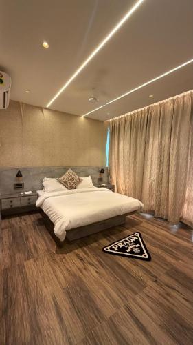 a bedroom with a large bed and a large window at Nova Bliss Villa in Nashik