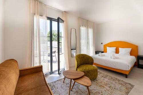 a hotel room with a bed and a chair at Eden Islands Marseille Prado in Marseille
