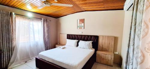 a bedroom with a large bed with a window at First Choice Hotel in Accra