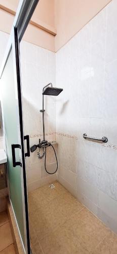 a shower in a bathroom with a glass door at First Choice Hotel in Accra