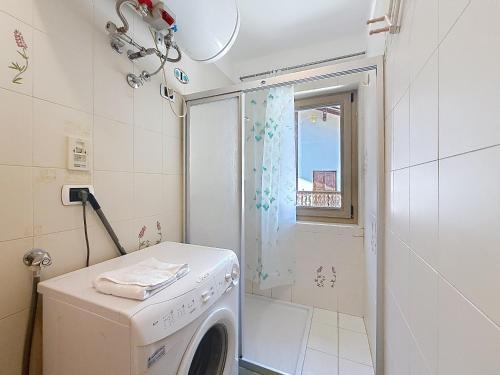 a washing machine in a bathroom with a shower at Cesa Fraines - Apt 28 in Alba di Canazei