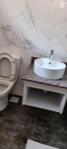 a bathroom with a toilet and a sink at ACK St.Julians Centre in Limuru