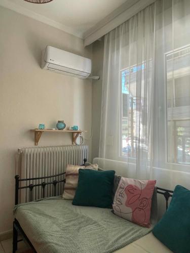 a bedroom with a bed with pillows and a window at Anastasia's House in Florina
