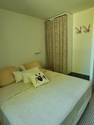 a bedroom with a bed with two pillows on it at Maison Caramel in Condorcet