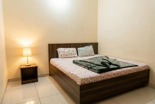a small bedroom with a bed with a night stand at Hotel Aarav Grand Chandigarh in Chandīgarh