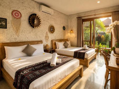 a hotel room with two beds and a balcony at D'Nanda mini hotel Ubud in Ubud