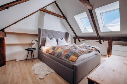 a bedroom with a bed in a attic with windows at KUL App 5 by Alpenidyll Apartments in Öblarn