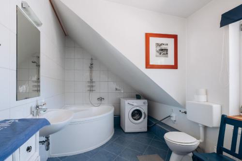 a bathroom with a sink and a washing machine at KUL App 6 by Alpenidyll Apartments in Öblarn