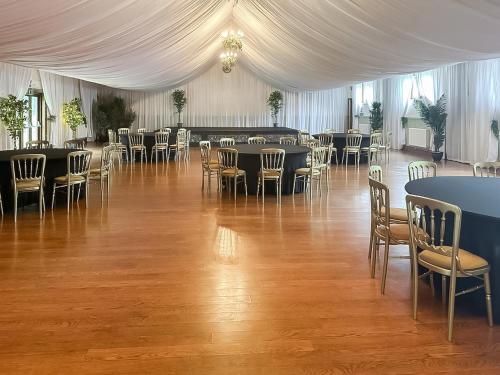 a banquet hall with tables and chairs in a tent at Duvale Priory - 9985 in Bampton