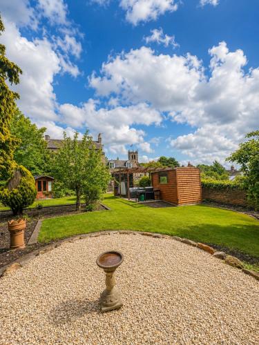 a garden with a stone circle in the middle at Lilac Cottage in Barnard Castle