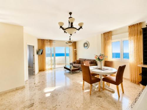 a living room with a table and chairs at Algaida, beach apartment in Mijas Costa