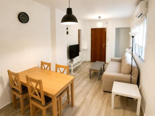 a living room with a table and a couch at Centre Sweet Home in Málaga