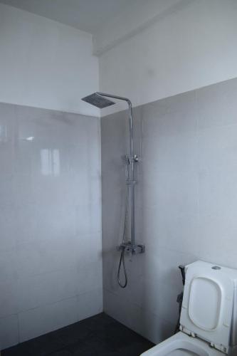 a bathroom with a toilet and a shower at Sentinels Hotel Kandy in Kandy