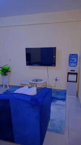 a living room with a blue cover on the floor at BREE'S EXECUTIVE STAYs in Kakamega