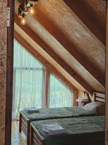 a bedroom with a bed and a large window at Tsiskari in Tsaldashi