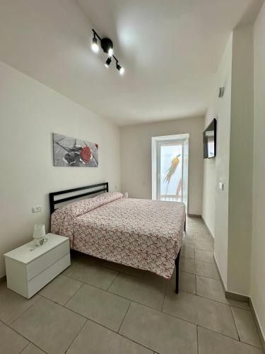 a bedroom with a bed and a table and a window at La casa di Stella in Isernia