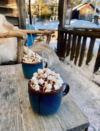 two cups of coffee sitting on a wooden table at Lillstugan in Sälen