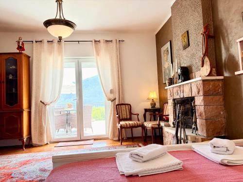 a living room with a fireplace and a large window at Villa Terrazza in Donji Morinj