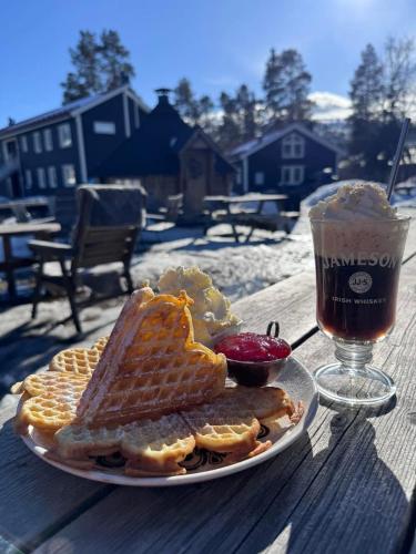 a plate of waffles and a drink on a table at Lillstugan in Sälen
