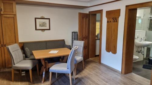 a dining room with a table and chairs and a sink at Adlerhorst , Gstan 31 in Finkenberg