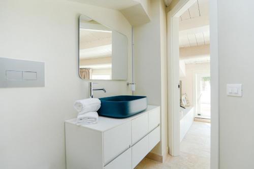 a bathroom with a blue sink and a mirror at Marina Homes Sea View Ortigia in Syracuse