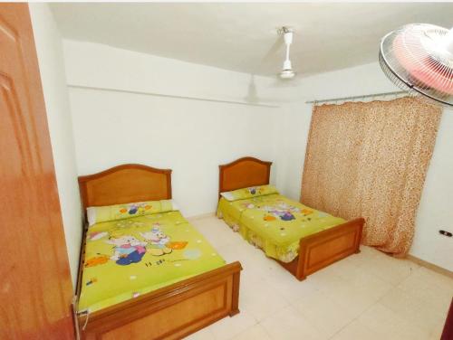 a bedroom with two beds and a window at Full board rent in Ras Sedr