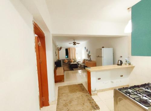 a kitchen and living room with a stove top oven at Full board rent in Ras Sedr