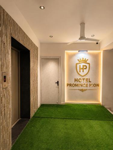 a hallway with a green carpet in a hotel promise room at Hotel Promince Icon in Ahmedabad