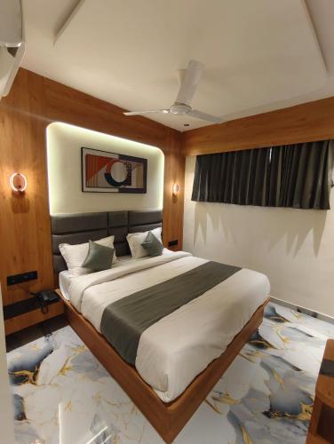a bedroom with a large bed in a room at Hotel Promince Icon in Ahmedabad