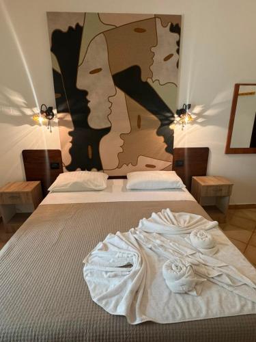 a bed with two white towels on top of it at Vistamare - Bed & Breakfast in Alliste