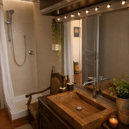 a bathroom with a wooden sink and a large mirror at Matteotti suite&gare in Asti