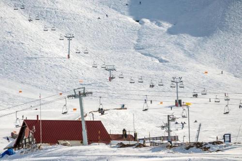 a snow covered ski slope with a ski lift at Departamentos Brown -WiFi 100 MB - Cochera - Parrilla - Aire - TV Cable in San Rafael