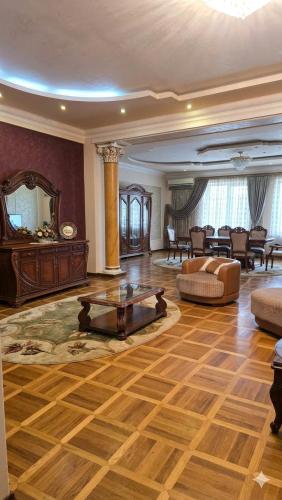 a large living room with a table and a couch at Elkasa guest house in Zvartnots International Airport