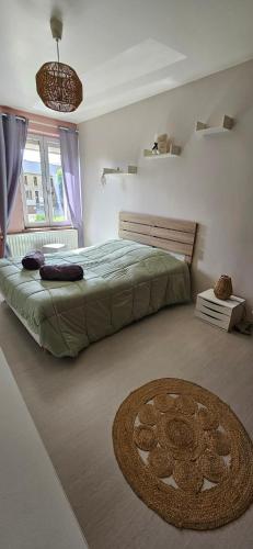 a bedroom with a bed and a circular rug at Chez Bya in Bouvellemont