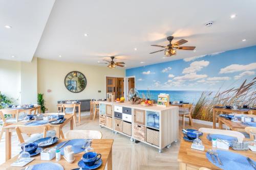 a dining room with a view of the ocean at Avoncourt Lodge in Ilfracombe