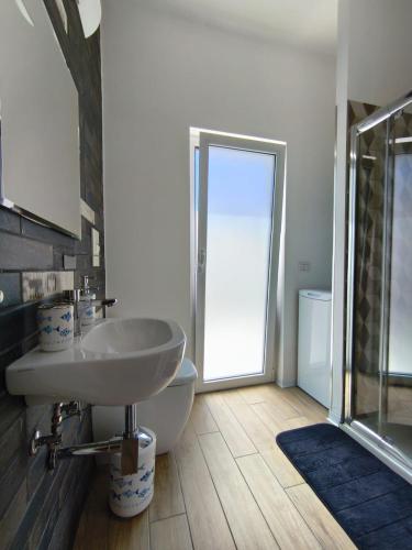 a bathroom with a sink and a toilet and a shower at La Terrazza dell'Abate in Maiori