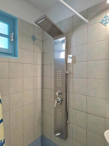 a shower with a glass door in a bathroom at nikola's house in Adamantas