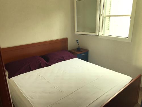 a bed in a bedroom with a window at Camping Porto Miggiano in Santa Cesarea Terme