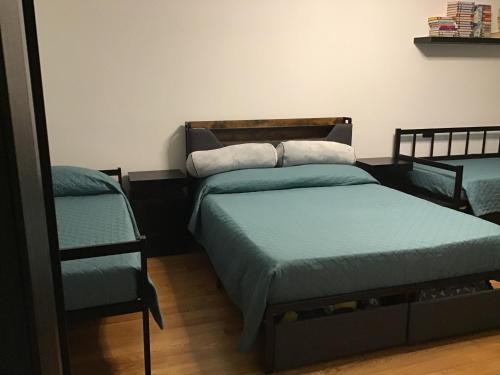 a bedroom with two twin beds and a shelf at My house in Turin